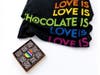Valentine's collections from Kokak Chocolates in San Francisco include "Love Is Chocolate," with T-shirt & truffles dressed in pride colors. 