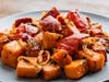Roasted sweet potatoes with peppers and onions are among side-dish options included with Urban Plates' Thanksgiving Turkey Family Feast, offered for takeout at locales in the SF Bay Area. 