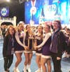 Sayville Varsity Cheerleaders and Coaches in Orlando display their trophy