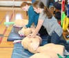 Students practice CPR techniques to music: Stayin' Alive 