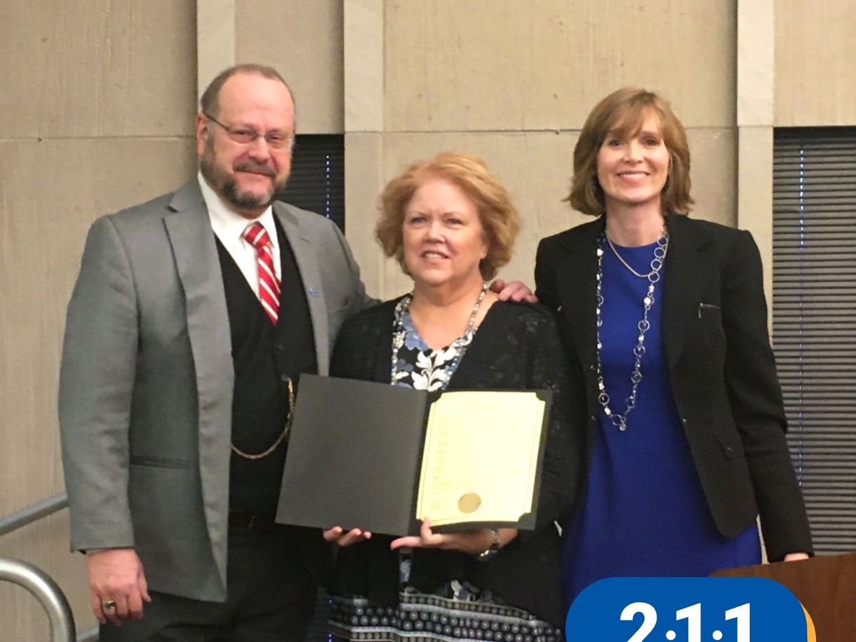 Lake County Board Member Steve Carlson and Lake County Board Chair Sandra Hart present 211 Day resolution to United Way of Lake County President & CEO, Kristi Long