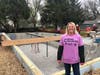 Homeowner Dawn is thrilled get her new Habitat Waukesha home framed, working with volunteers from local companies.