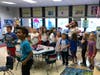Mrs. Reeks and her class react to the news that he has been named Hero of the Month.
