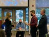 Julie Berry is sworn in by her son while her husband looks on.