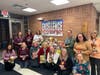 Fulton staff show off some of the items their student council collected before being donated.