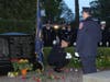 Roses are placed near the memorial after the reading of the names.