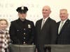 Officer Kyle Lucia with Mayor Theresa Trouvé, Commissioner Kenneth Jackson and Trustee Mark Hyer.