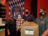 Mayor Theresa Trouvé, assisted by Domenick Stanco, deputy superintendent of the Department of Public Works, and Street Department employee Frank Brusack, delivers Personal Protective Equipment (PPE) kits to Prost employee Tanya Handler on December 4.