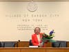 Mayor Theresa Trouvé receives flowers before presiding over her final Board of Trustees meeting March 25, 2021.