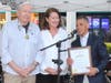 Jockey Javier Castellano thanks Mayor Mary Carter Flanagan for the recognition during a ceremony at the Belmont Festival on Seventh Street June 9 as Garden City Chamber President John Wilton looks on.