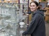 A Thriftastic Job Readiness student stocks glassware at The Bridge Thrift Store in Orland Park, Illinois. 