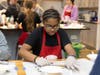 A Bridge student rolls homemade tortellini pasta during a free culinary program at The Bridge Teen Center.