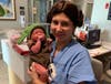 The Patrick family’s newborn baby girl with Franciscan Health nurse Nora Savaglio.
