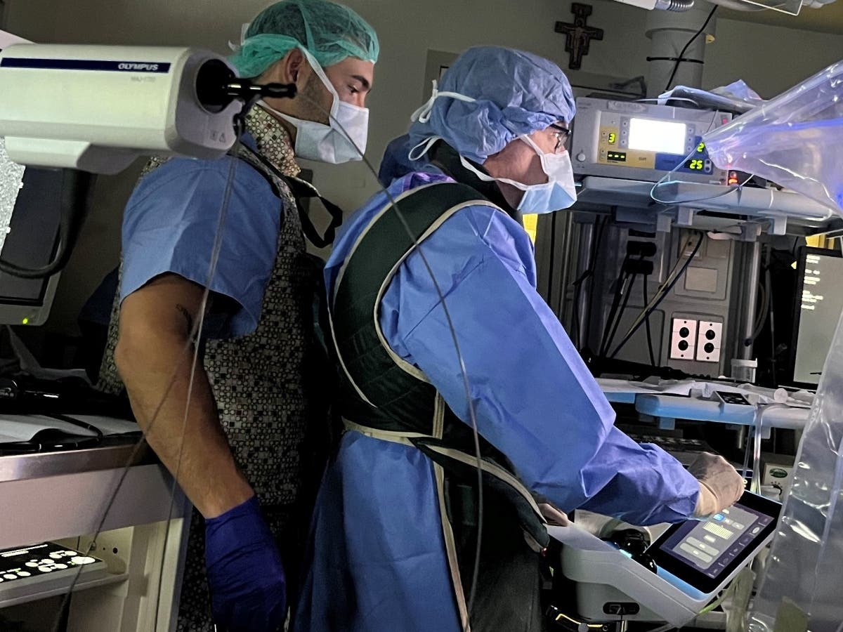 Marko Ristic of Intuitive Ion (left) watches Specialty Physicians of Illinois, LLC, pulmonologist Bradley Coolidge, MD, during the first Ion Robotic Bronchoscopy procedure performed at Franciscan Health Olympia Fields in September.