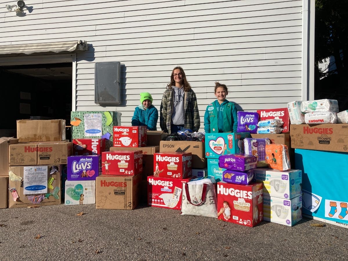Local Girl Scouts make a delivery of diapers and undergarments to the Jonnycake Center.