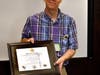 Plymouth Township Environmental Advisory Board member Bill Sabey accepts an award on behalf of the township.