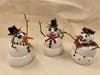 Glazed and fired, the snowmen are ready for the holiday season.