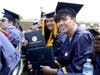  RCSJ-Gloucester graduates show off their diplomas during the May 12, 2023, Commencement ceremonies.