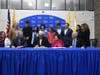 Dr. Fred Keating (left), RCSJ President, Mike Girone (right), Rowan College Foundation Chair, family, and friends look on as Frank Messina (center), Gaetano Foundation Founder, signs the Gaetano Messina “Start Smart” Scholarship agreement with RCSJ.