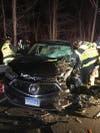Firefighters work to extricate occupants of SUV.