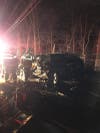 Firefighters work to remove door of damaged SUV.