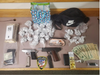 Police seized heroin, two loaded guns, cash and more during a traffic stop Monday night in Wallingford.