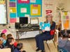 West Haven Mayor Nancy R. Rossi reads the 1957 Dr. Seuss children’s book “The Cat in the Hat” to second-grade students.