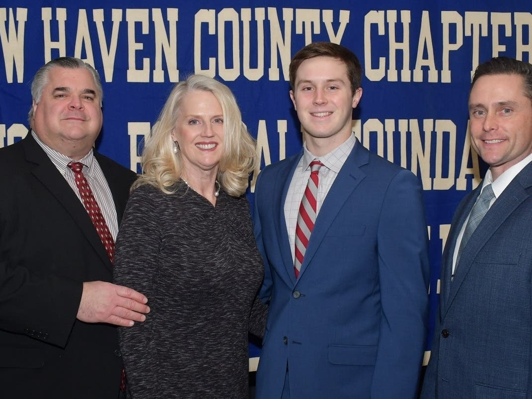 Branford's Phil DeLise Jr., of Hopkins School in New Haven, with his parents Phil and Lois (left) and coach Tim Phipps.