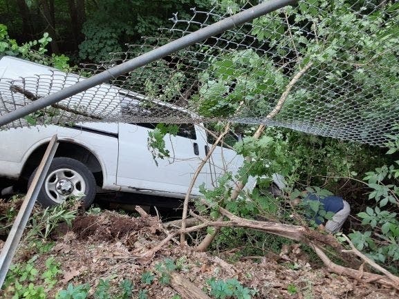 A utility van crashes into a river at a housing complex Thursday in Connecticut.