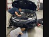 Everyone pitches in to help rescue a kitten trapped inside an engine Friday morning at Hamden Auto Body.