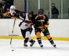 North Haven's Eli Brubacher battles for the puck.