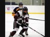 North Haven's Will Fiore keeps the puck from an East Haven defender.