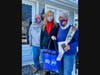 Mayor Nancy R. Rossi, center, delivers a red rose and a blue tote bag containing other valentines to Bill and Doreen Breen as part of West Haven’s 31st annual Valentine’s Day event Friday.