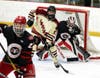 North Haven's Jake Hines looks for the puck in front of Cheshire goaltender Amaan Chaudhry.