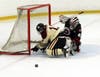 North Haven's Jake Hines greets Cheshire goaltender Amaan Chaudhry.