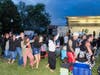 Partygoers form an impromptu conga line with members of The Pop Rocks, “Connecticut’s ultimate ’80s experience,” during West Haven’s centennial celebration.