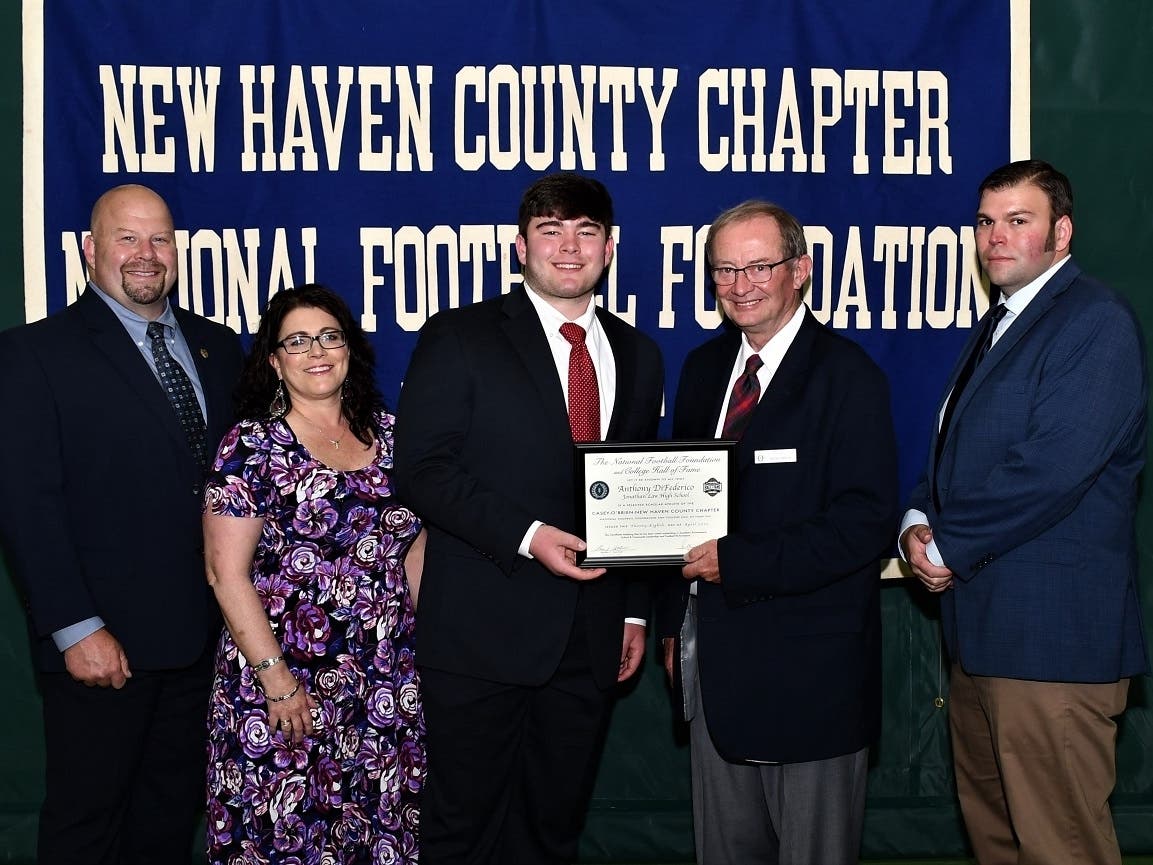 Jonathan Law’s Anthony DiFederico with his parents John and Denise, scholar athlete chairman Kevin O'Brien and coach Christopher Haley.