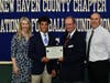 Xavier’s Haydon Tomlin, of North Haven, with mother Amy, scholar athlete chairman Kevin O'Brien and coach Andy Guyon.