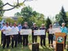 U.S. Rep. Rosa L. DeLauro and Mayor Nancy R. Rossi display oversize checks for four FEMA grants totaling $1.23 million to West Haven's three fire departments during a news conference on Monday.
