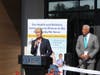 Mayor Nancy R. Rossi delivers remarks celebrating the Cornell Scott-Hill Health Center’s new care site in West Haven as CEO Michael R. Taylor looks on. 