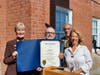 Phil Liscio receives a General Assembly citation from state Rep. Dorinda Borer, D-West Haven, right, on behalf of the city’s delegation as Mayor Nancy R. Rossi and Executive Assistant Louis P. Esposito Jr. look on. 