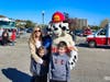 Sparky the Fire Dog interacts with Ivory Urban, of Orange, and her sons, from left, Ashton, 1, Bryson, 6, and Conrad, 8.
