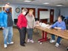 Author Dan Shine signs a paperback copy of the new West Haven centennial book for lifelong Westie Carol Gunning, third from left, as Village Improvement Association President John Galvin and city Human Resources Commissioner Beth A. Sabo look on.