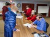 West Haven author Dan Shine and Mayor Nancy R. Rossi take turns signing a paperback copy of the new centennial book, “City of West Haven: Village to Town,” for residents Eleanor and Donald Froehlich at the Main Library on Monday night.