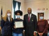 West Haven High junior Ayannah Obas receives a Black Heritage Committee award for leadership from Chairman Steven R. Mullins as, from left, Mayor Nancy R. Rossi and Obas’ mother, Nadia Obas, look on.