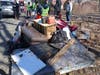 Piles of trash collected by volunteers with the Sandy Point Neighborhood Association on Sunday.