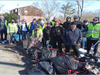 Volunteers from Sandy Point Neighborhood Association and Hopkins School take a break after cleaning two littered vacant lots on Peck Avenue in West Haven.