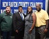 Hamden Hall's Amari Phillips, from Branford, with assistant coach Steven Reynolds (left) and parents Leah and Yancy.