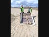 SPNA President Michelle Coletti, left, with Peck Avenue resident, Lisa Avellino remove a box frame that had washed up on the beach.