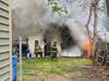 Firefighters battle a garage fire on Jean Street in Hamden on Sunday afternoon.